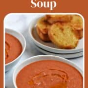 A bowl of bright orange gazpacho soup drizzled with olive oil and title graphic across the top.