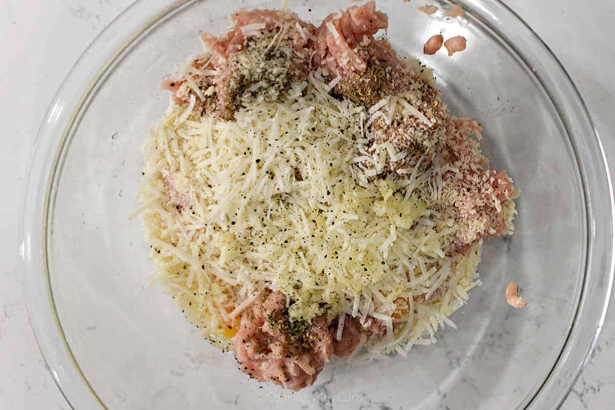 Ground chicken, parmesan, seasonings, and egg in mixing bowl.