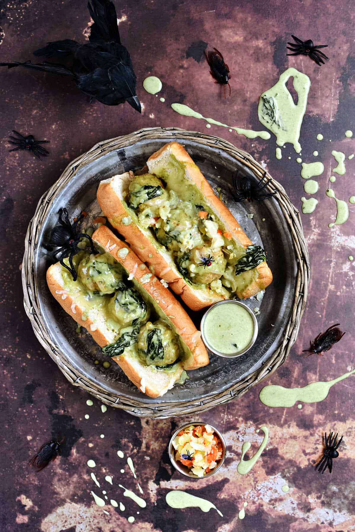 Meatballs with Alfredo sauce and spinach in hoagie rolls with extra sauce on the side.