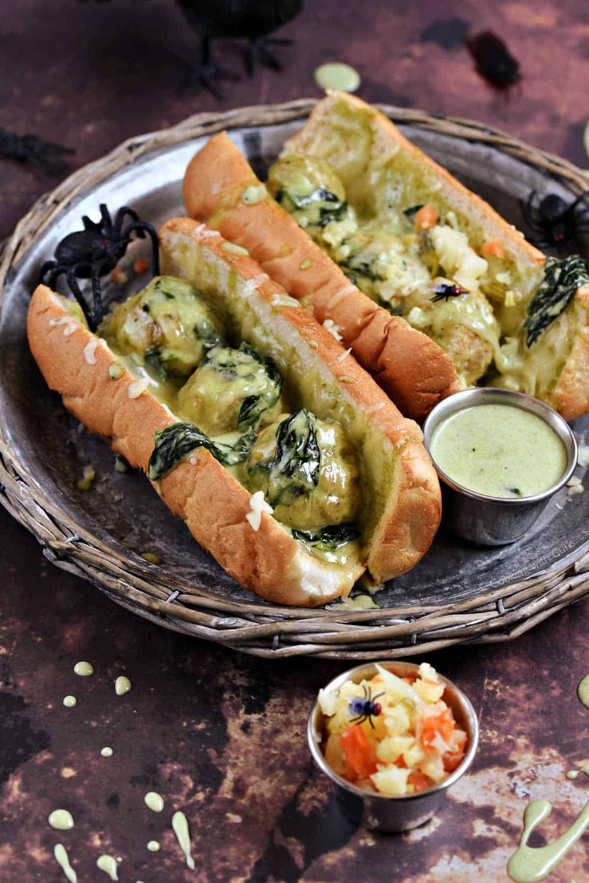 Meatballs with Alfredo sauce and spinach in hoagie rolls.