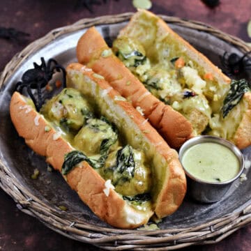 Meatballs with Alfredo sauce and spinach in hoagie rolls.