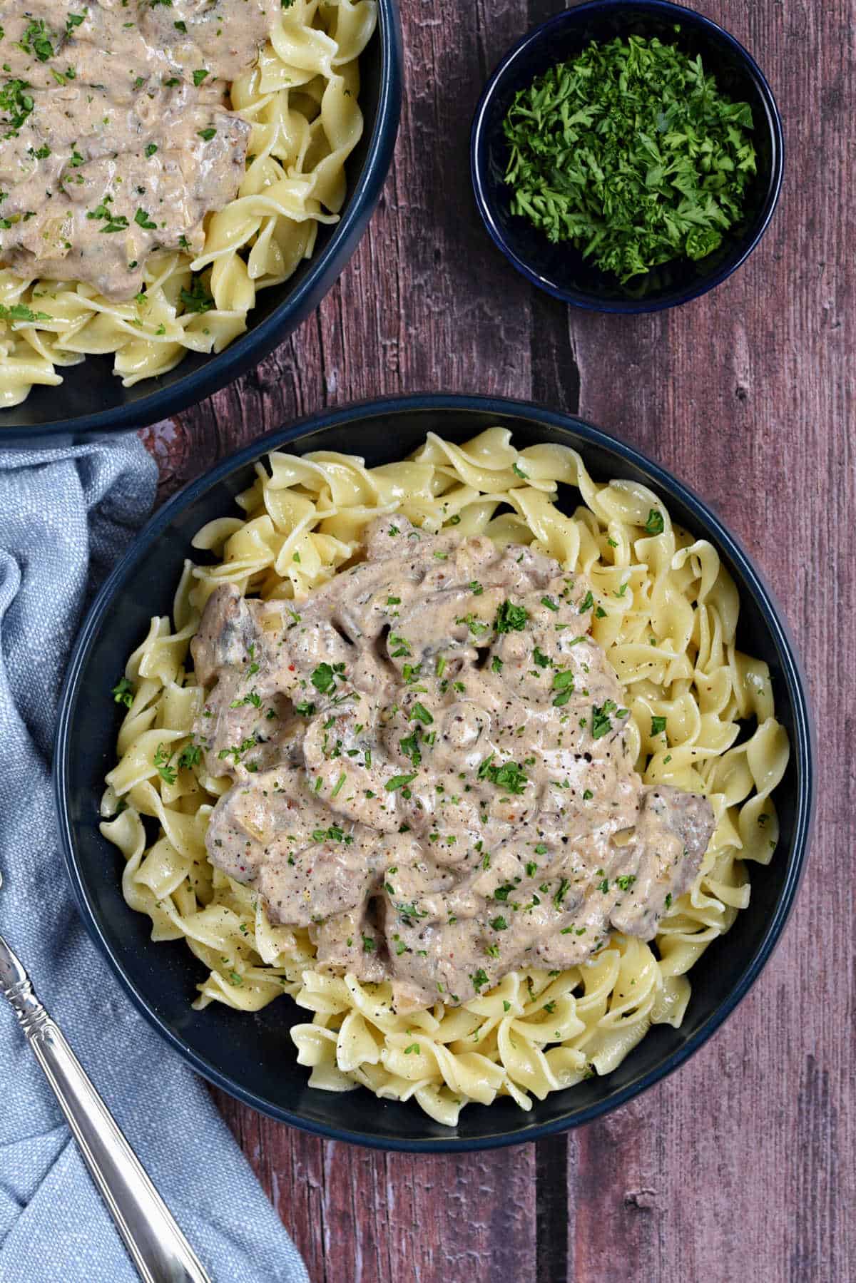 Creamy beef stroganoff on a bed of noodles.