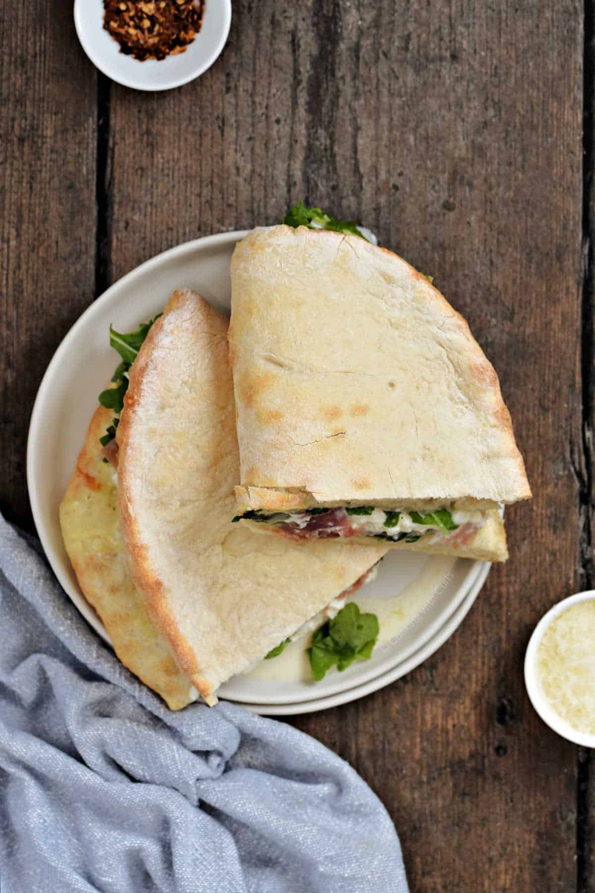 Panuzzo sandwich cut in half and stacked on a small plate.