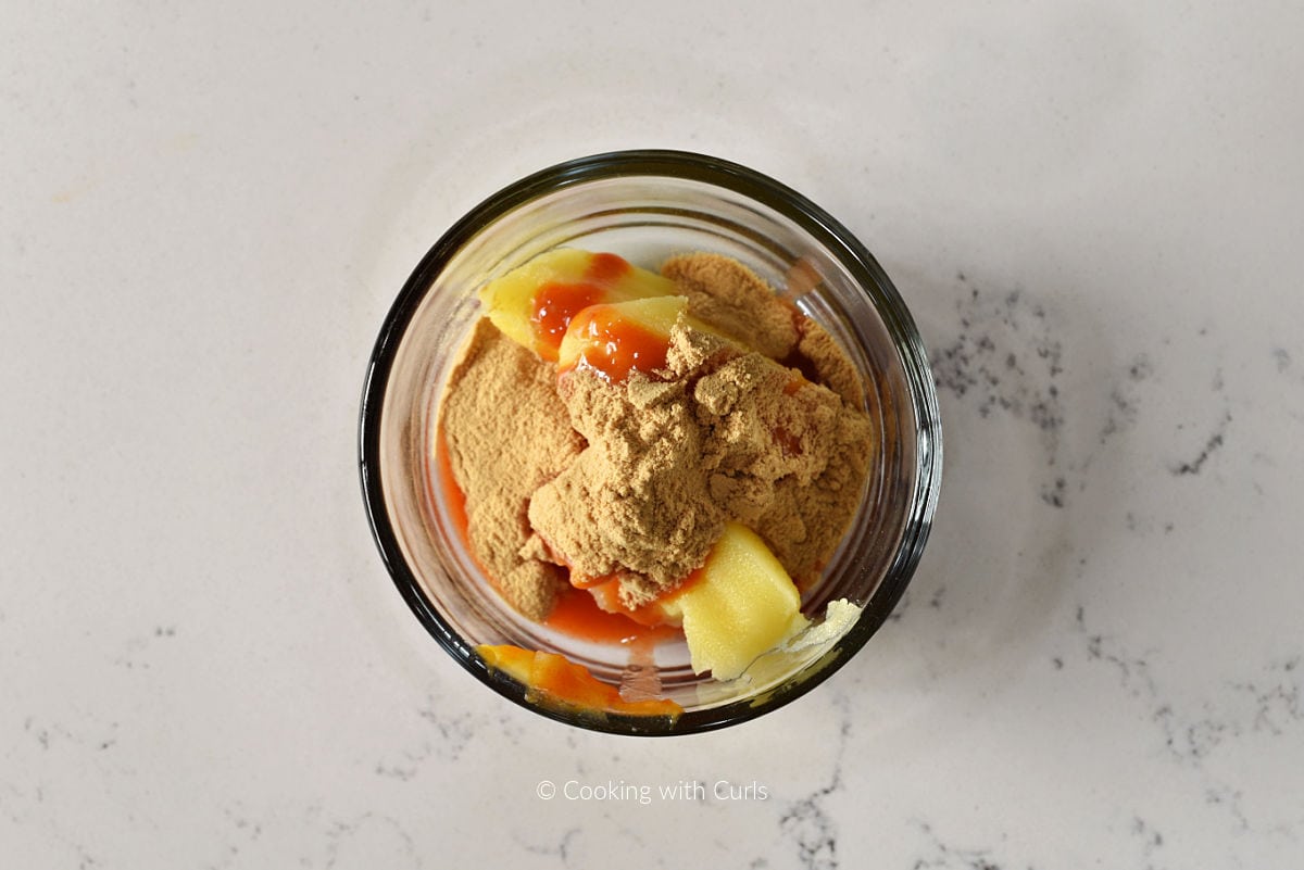 Ghee, chicken bone broth powder, and hot sauce in small bowl.